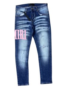 Amiri em azul-claro com o logótipo rosa em destaque acabamento deslavado e rasgados subtis.